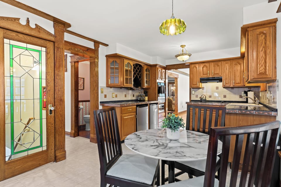 Start your morning in this cozy breakfast nook surrounded by vintage charm and warm natural light.