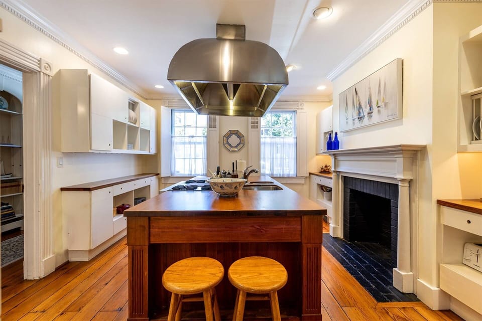 The full kitchen is fully stocked for your stay and ready to host a family meal (non-working decorative fireplace).