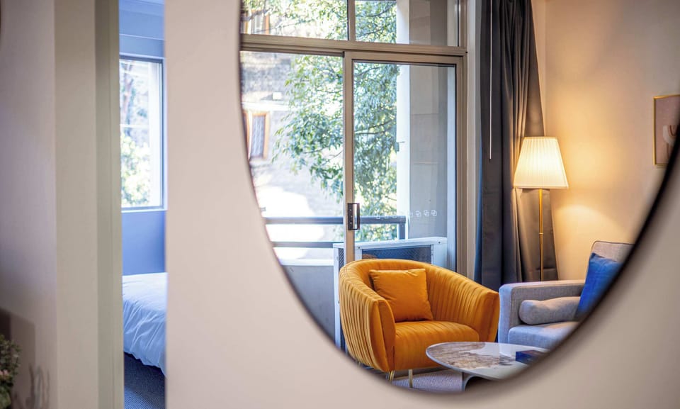 Living room detail showing cozy seating area and reading nook and 1.2m round mirror