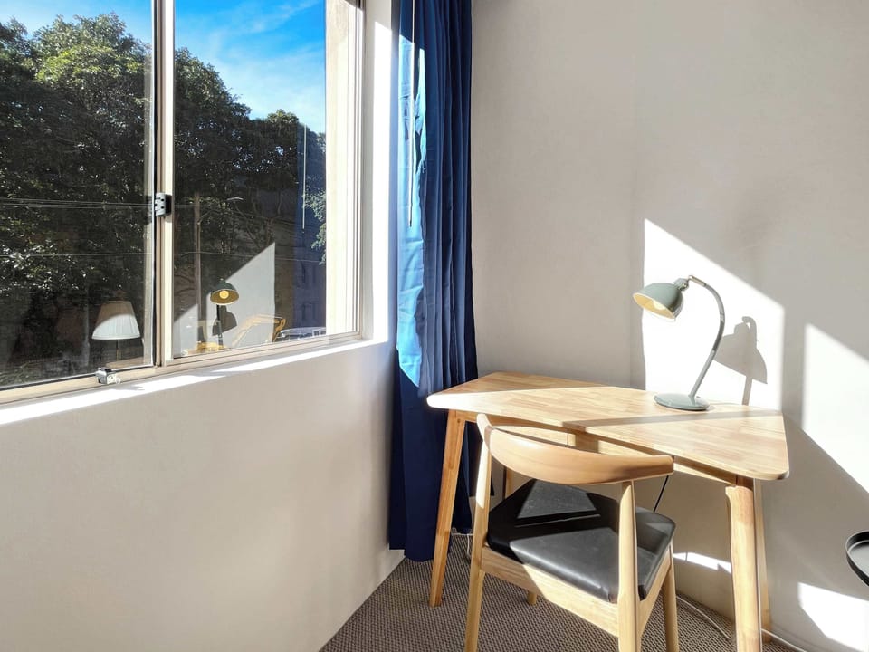 Study nook by the window with desk and chair, ideal for working remotely.