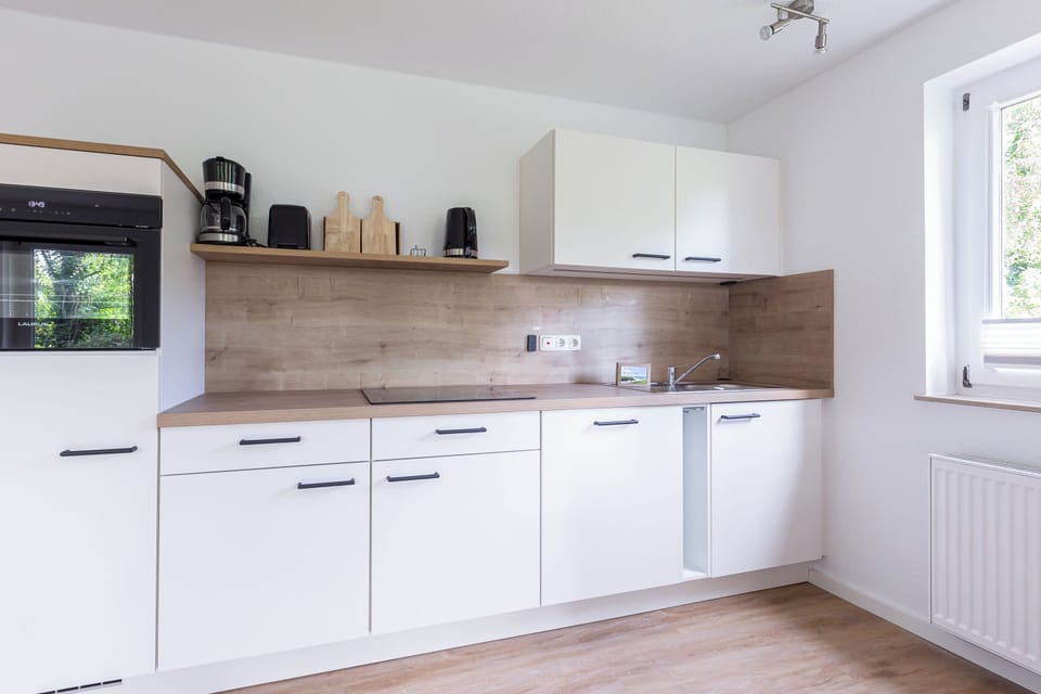 Modern kitchen with wooden shelves and appliances