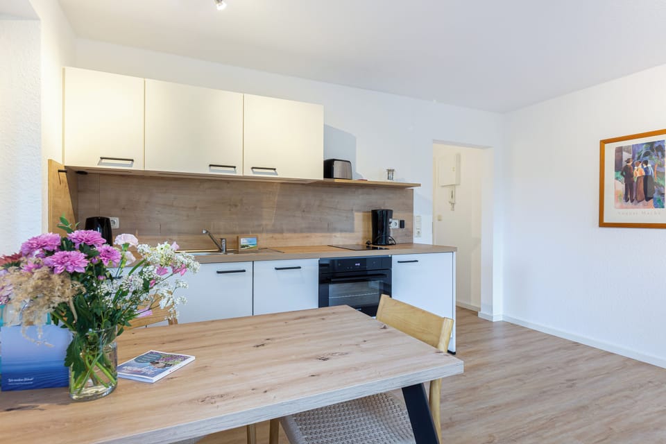 Modern Kitchen with Dining Table and Wooden Surfaces