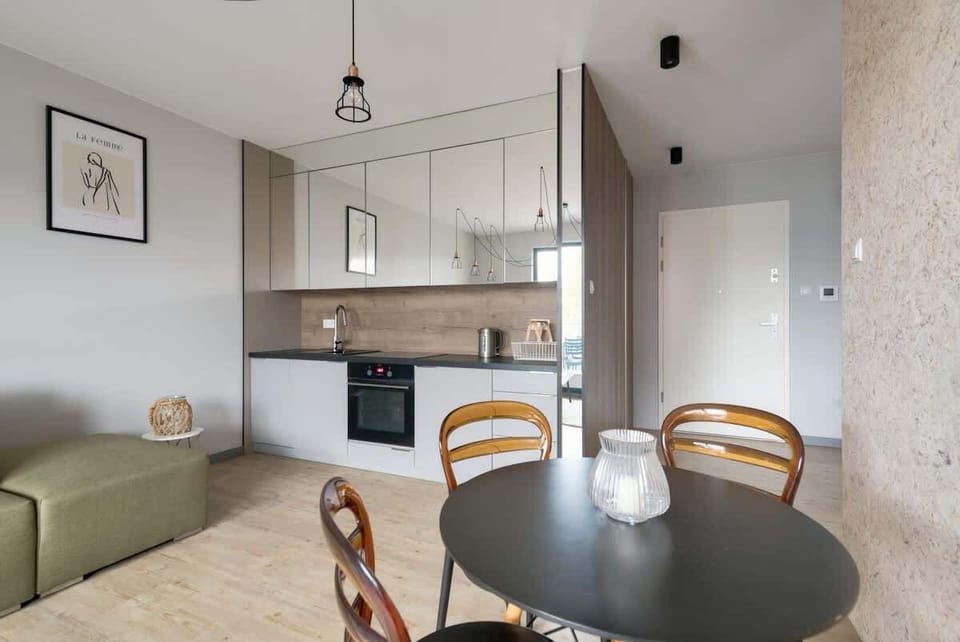 A spacious living room with a fold-out sofa and modern decor.