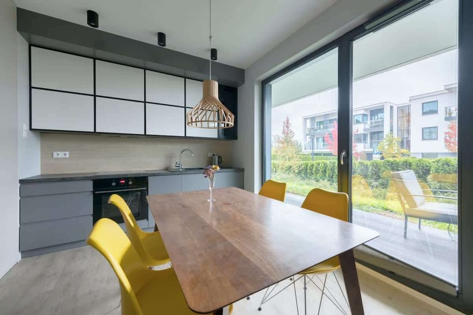 Sleek cabinetry and a stylish dining table create a perfect space for shared meals.