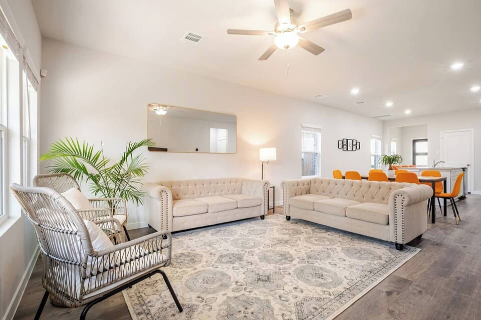 Gather in this bright, inviting living room featuring two Chesterfield sofas.