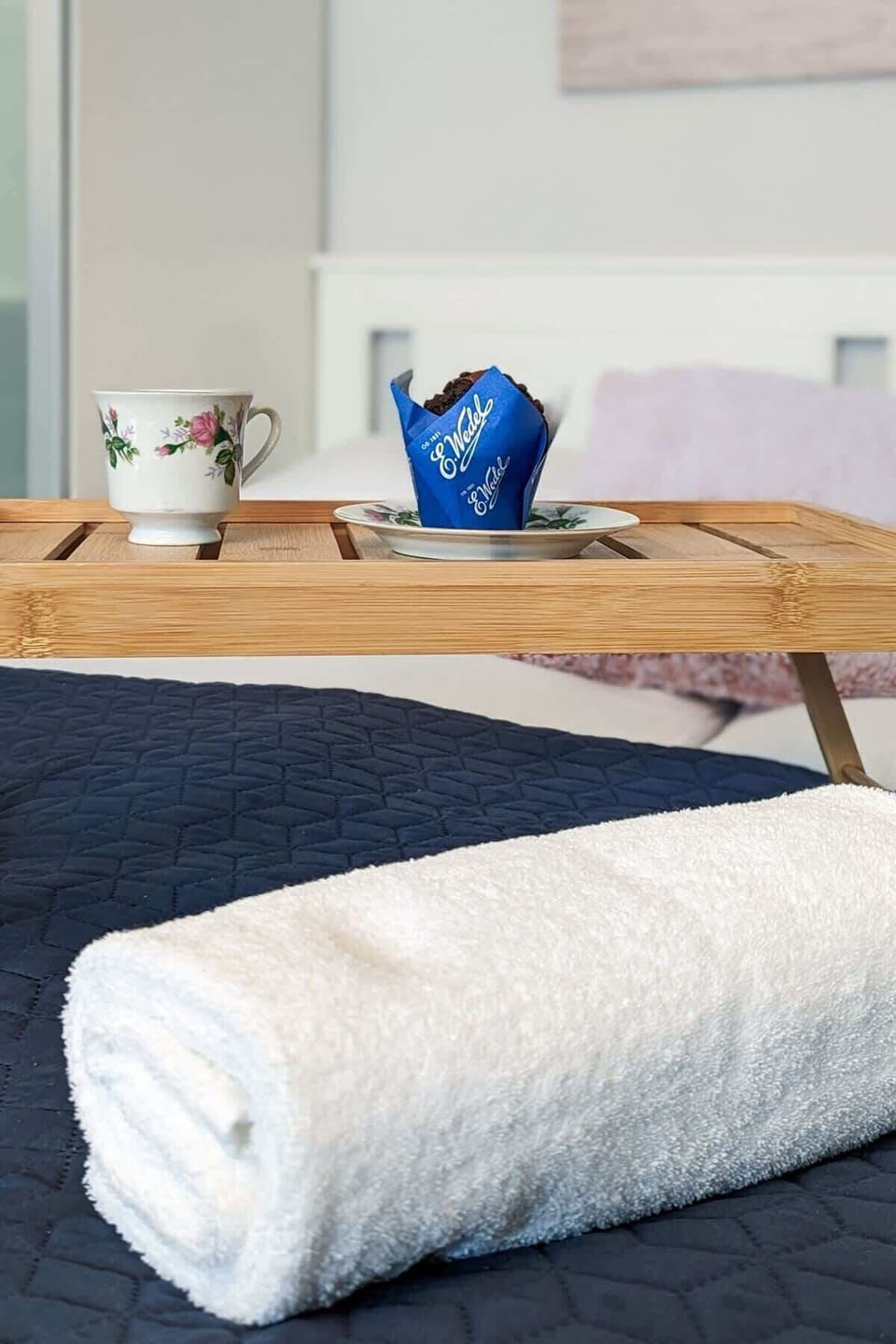 A close-up of rolled towels on the bed, adding a touch of hospitality and care.

