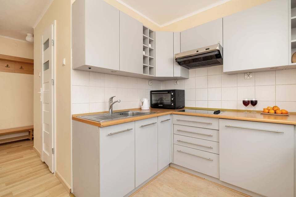 Kitchen with plenty of kitchen utensils and dishes. 
