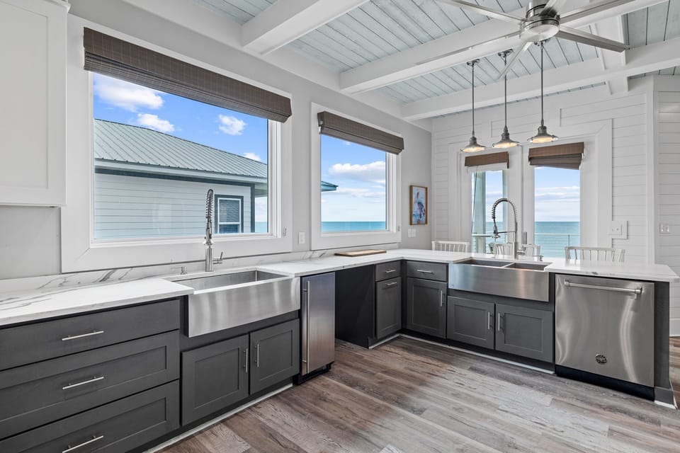 Your gourmet kitchen boasts stunning ocean views while you prepare meals with professional-grade appliances and sleek marble countertops.