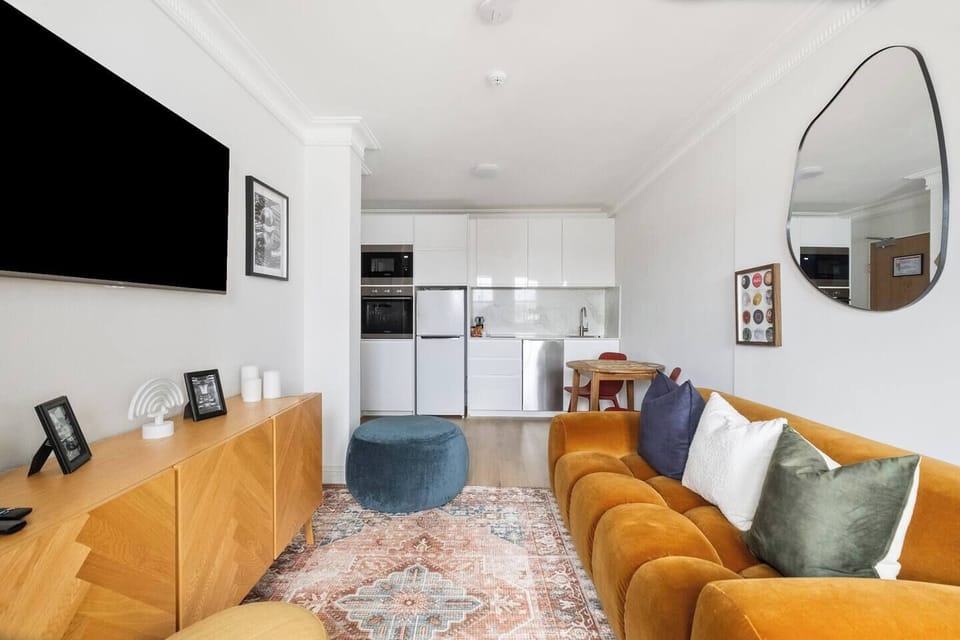 The apartment’s open-plan design flows effortlessly from lounge to dining, creating a light-filled, functional space ideal for relaxing or working remotely.