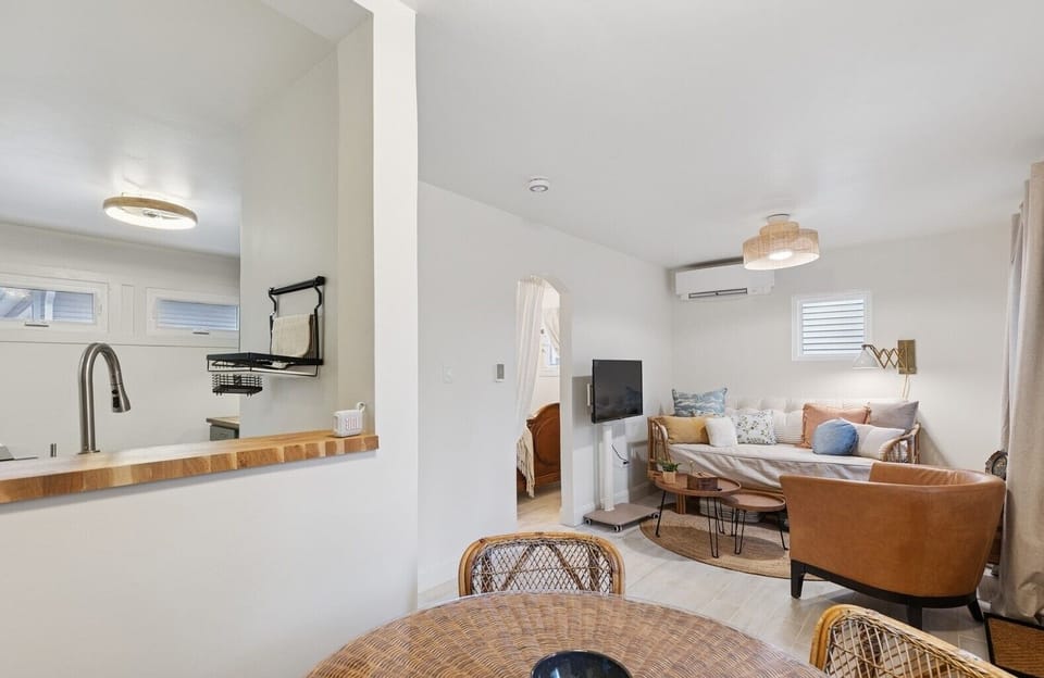 View from dining area into Kitchen/Living room. Far doorway goes into bedroom.