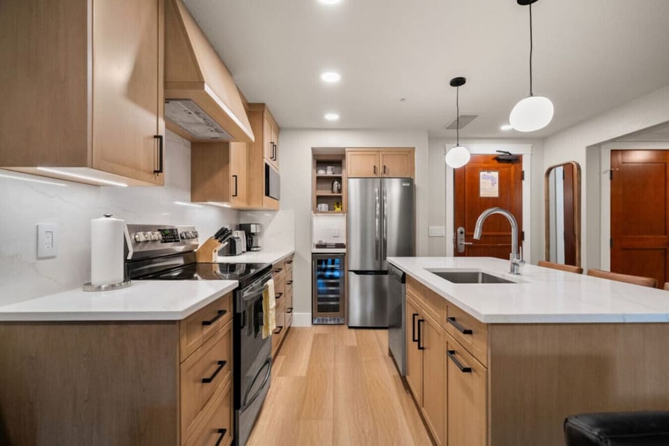 Your kitchen features natural wood cabinetry and a pantry for your use.