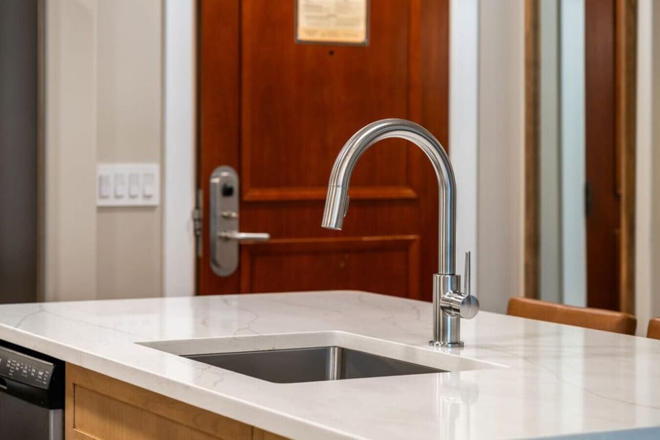 A close-up of the modern kitchen sink and faucet.