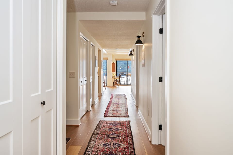 Entry hallway leads from front to back of condo. Bedrooms and bathrooms are on either side of the hallway leading to the eating and dining areas & lake front balcony. 