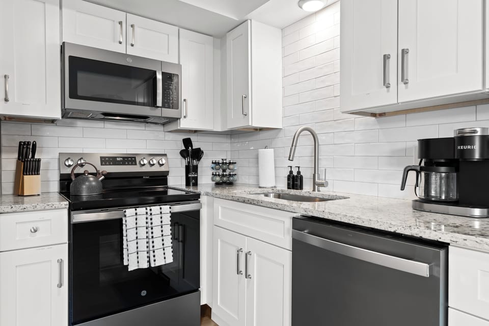 Fully equipped kitchen with stainless steel appliances and sleek finishes for easy meal prep.