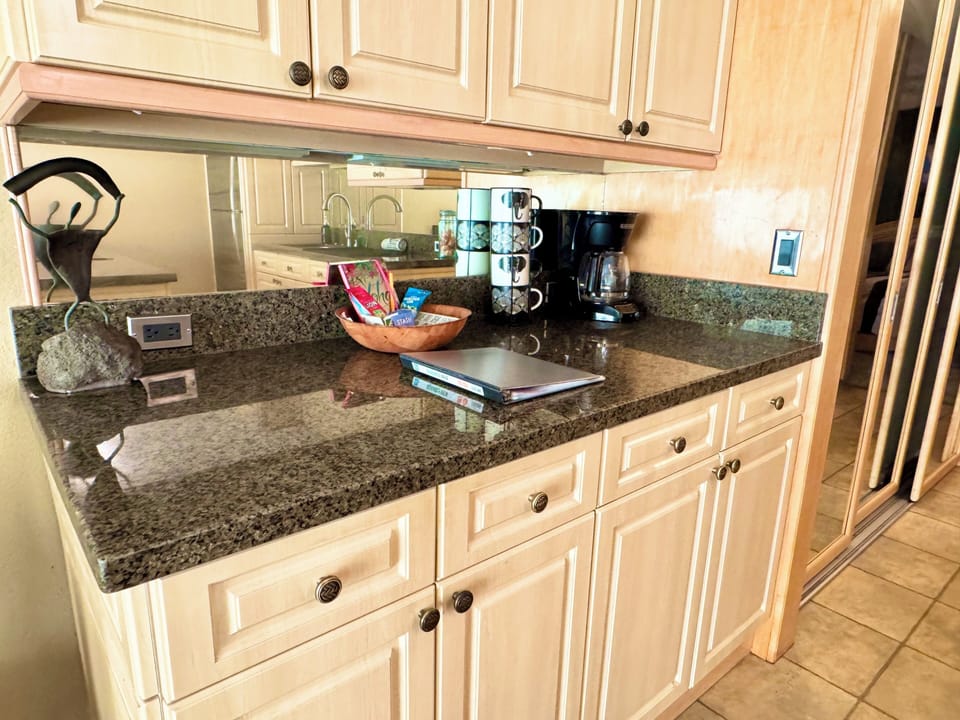 Fully stocked kitchen with coffee maker.