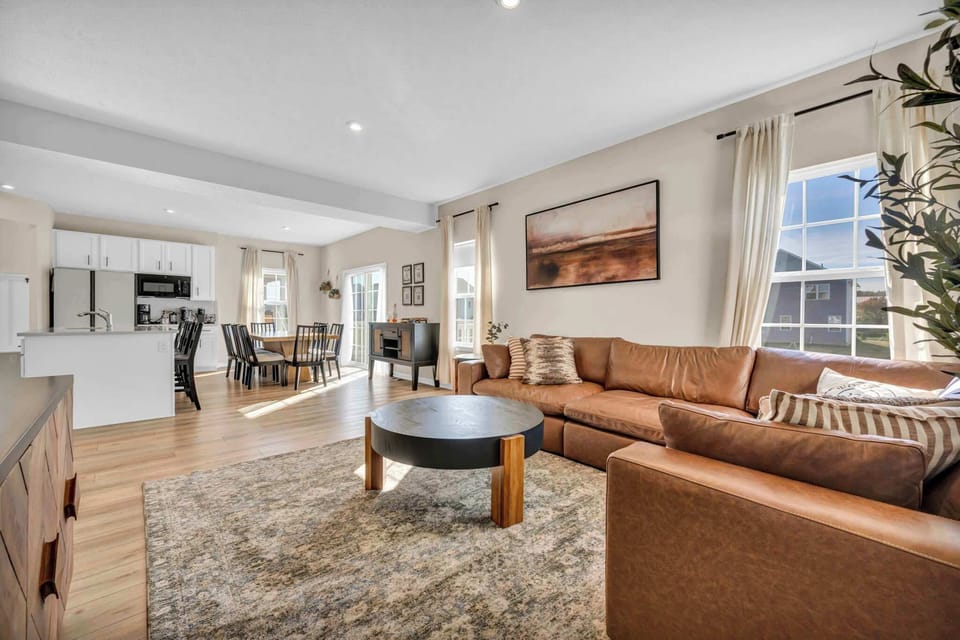 Bright & Inviting Living Area
Unwind in this open-concept living space featuring a plush leather sectional, warm natural light, and modern décor. The seamless flow to the dining area and kitchen makes it perfect for gathering with family or friends. 
