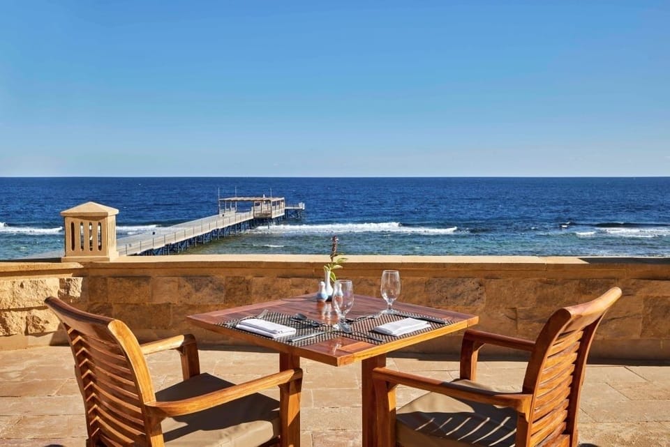 Toast the waves from your private table with endless views.