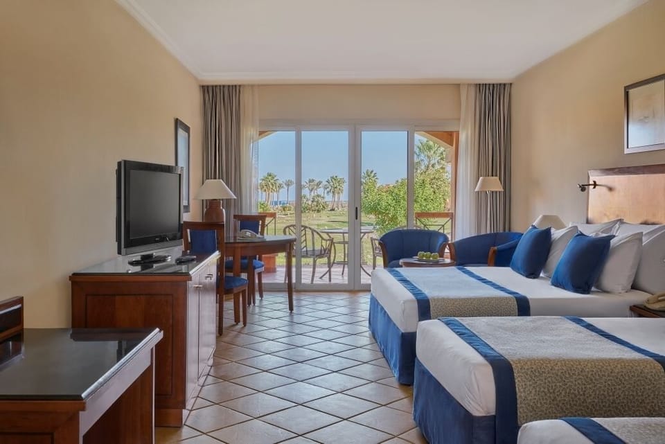Stretch out in an airy room overlooking palms and gardens.