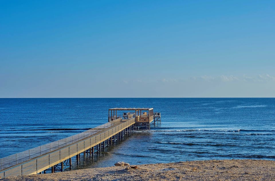 Stroll out over the sea for serene sunrise moments.