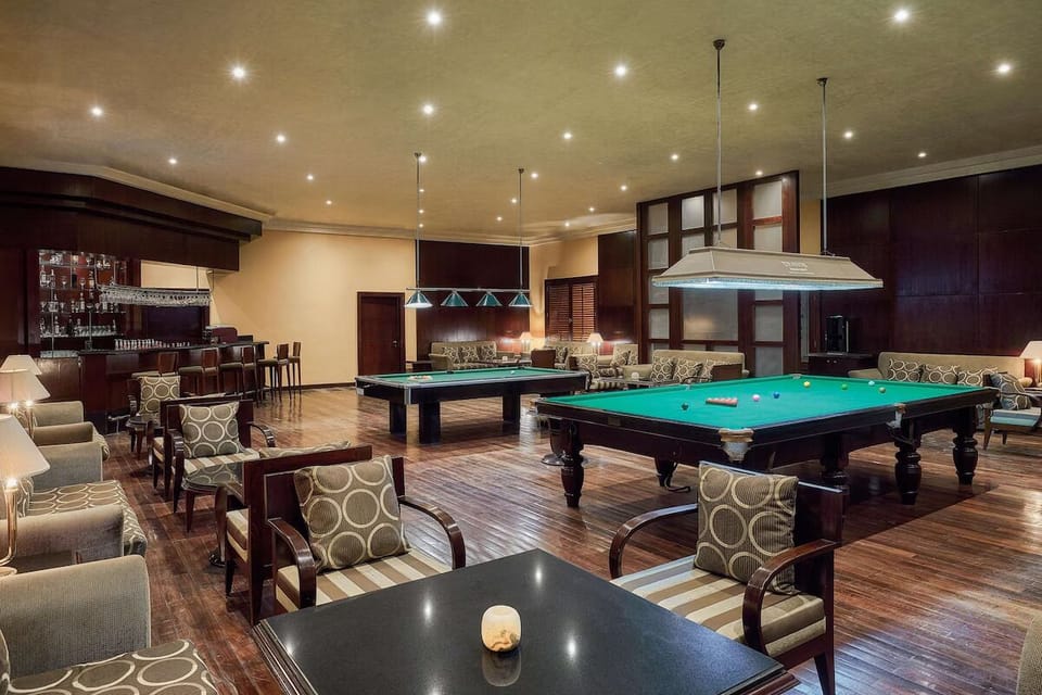 Challenge friends to billiards in a warm, club-style lounge.