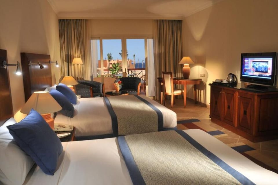 Settle into twin comfort with ocean glimpses beyond the balcony.