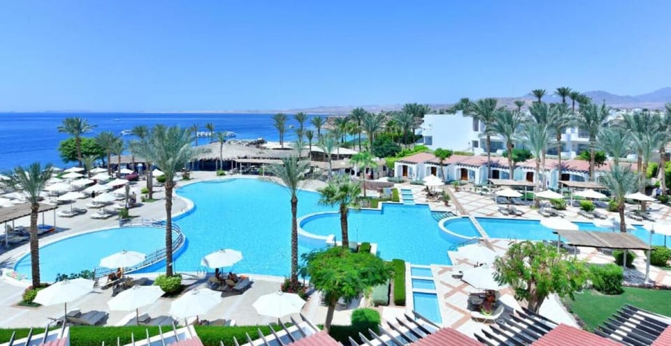 Soak up sweeping sea views across expansive resort pools.