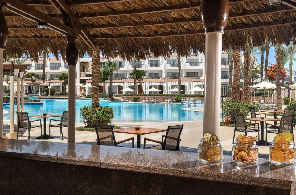 Lounge poolside with refreshing drinks steps from the water.