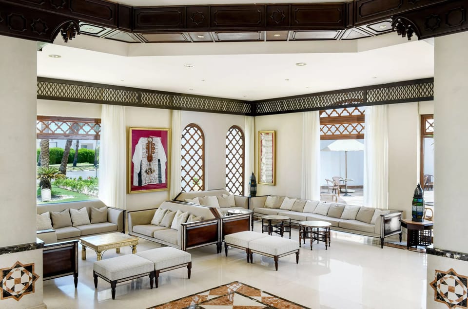 Unwind in airy lobby lounges with palm-framed garden views.