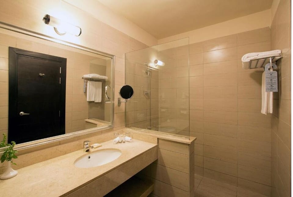 Refresh effortlessly with a spacious vanity and glass shower.