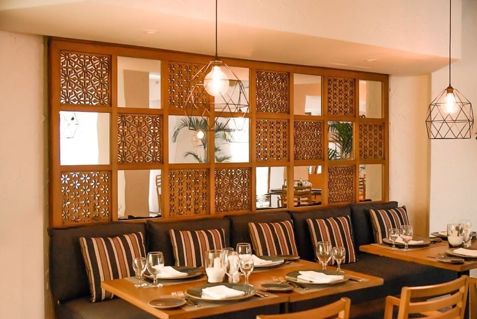 Enjoy relaxed dining in cozy booths with elegant lantern lighting.