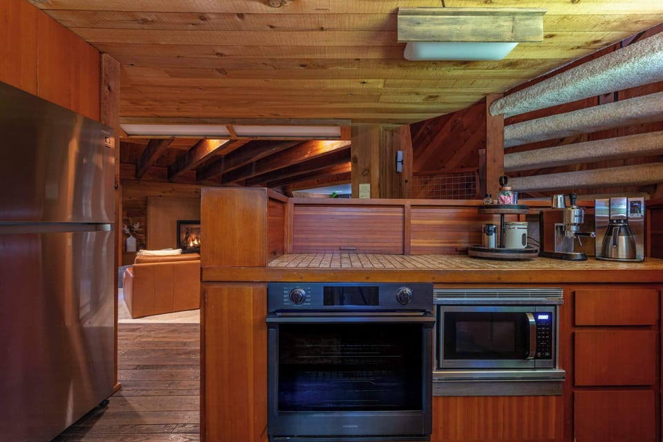 A kitchen with a view into the living room.