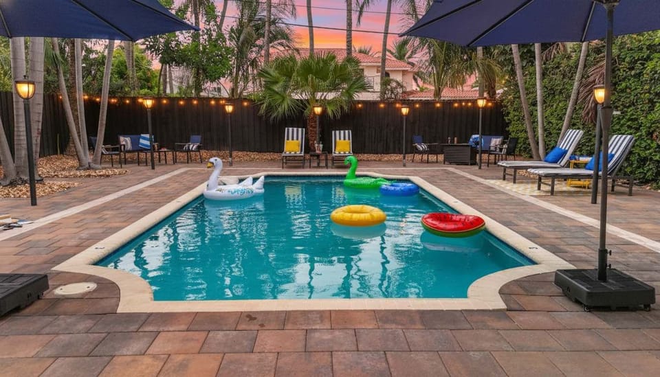 End your day with a swim in the heated pool while the sky turns golden. Plenty of loungers and seating make it easy to relax outdoors. #FtLauderdaleRetreat #PrivatePool