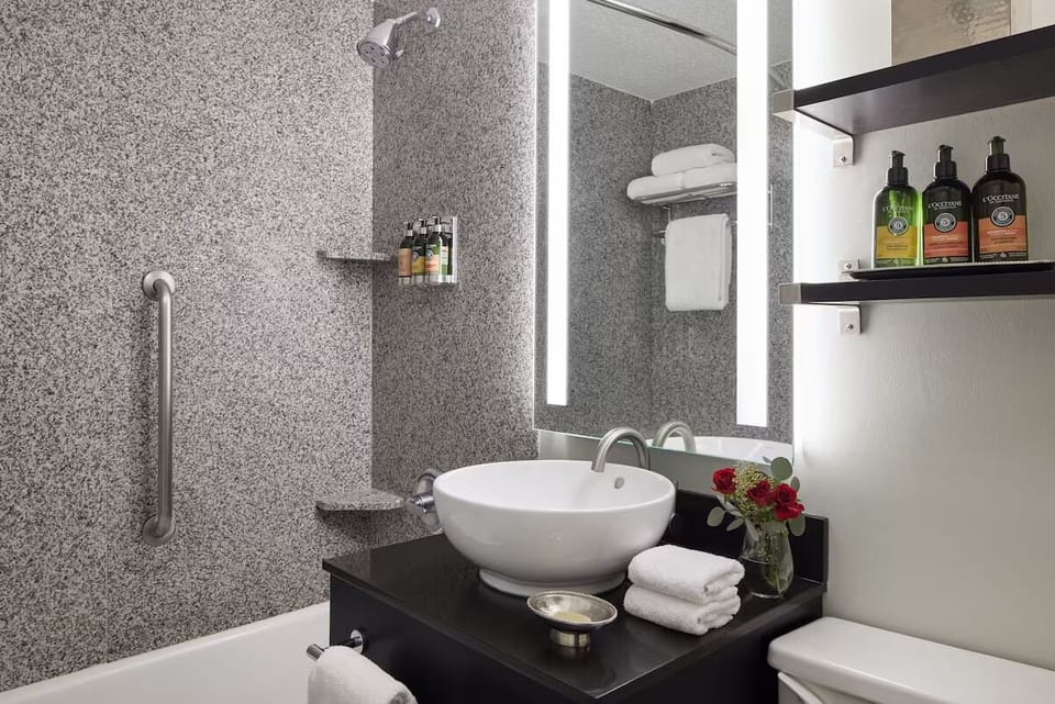 Refresh under bright lights with fluffy towels within reach.