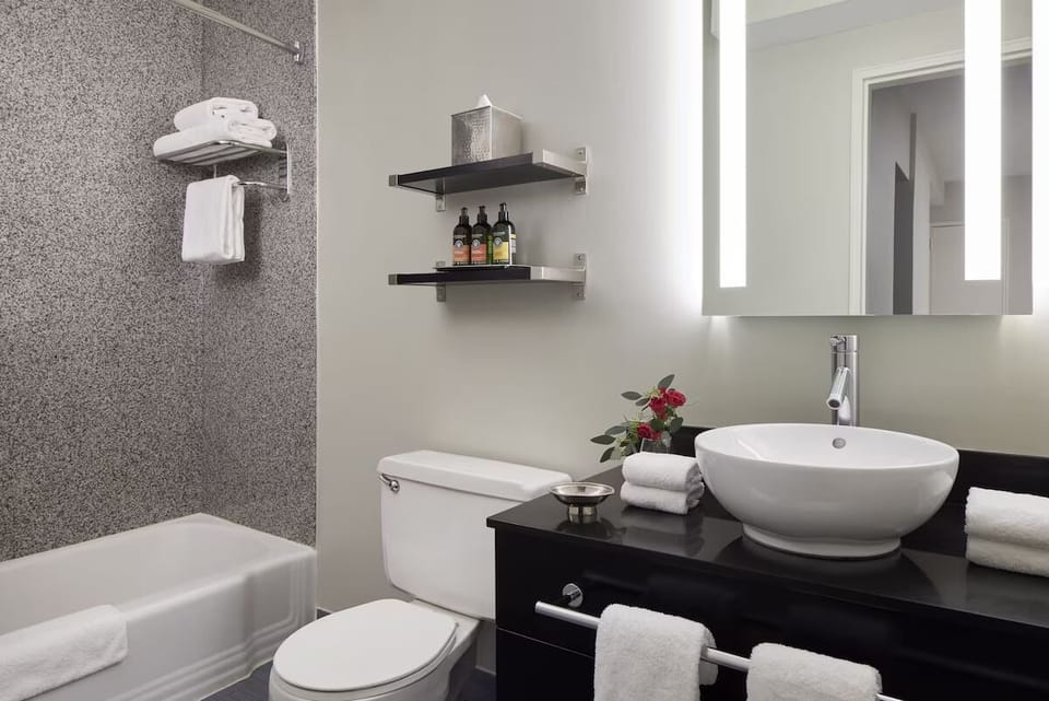 Refresh with fluffy towels and a bright vanity mirror.