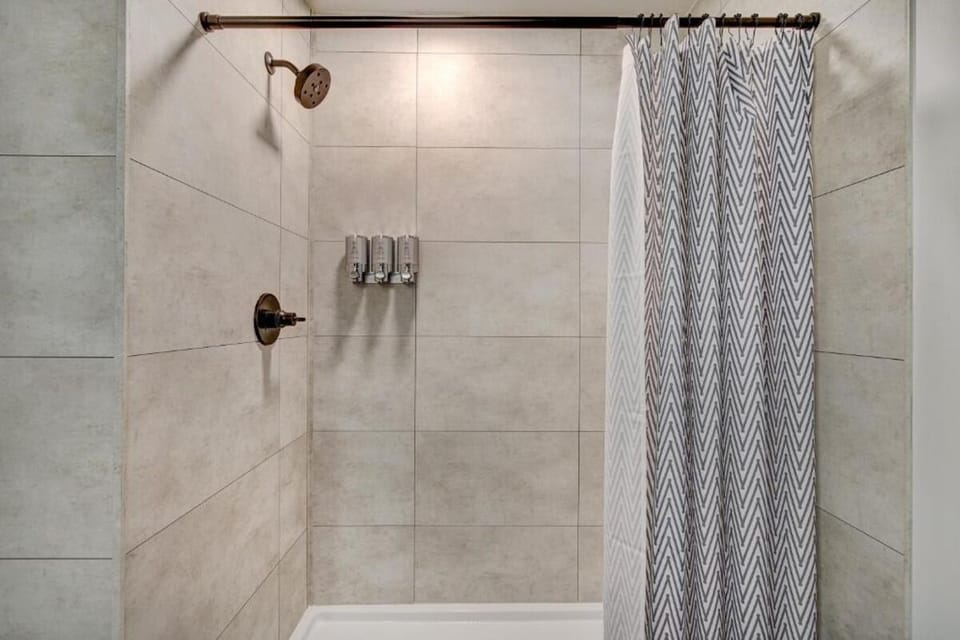Step into a roomy shower with spa-style wall dispensers.