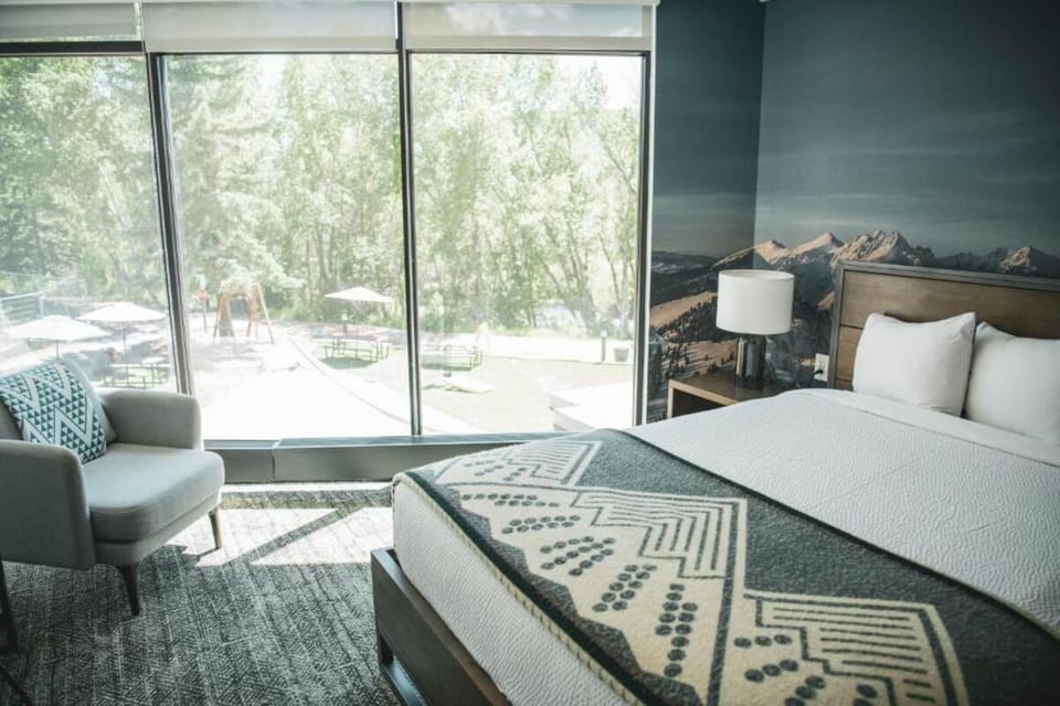 Lounge by floor-to-ceiling windows with calming garden views.
