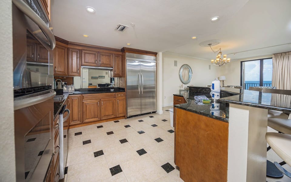 Spacious kitchen featuring rich wood cabinetry, sleek countertops, and modern stainless appliance upgrades