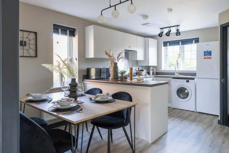 Cook up your favorite meals in our fully equipped, stylish kitchen featuring an oven, stove, microwave, refrigerator, and washing machine. This modern space has everything you need for a comfortable stay.