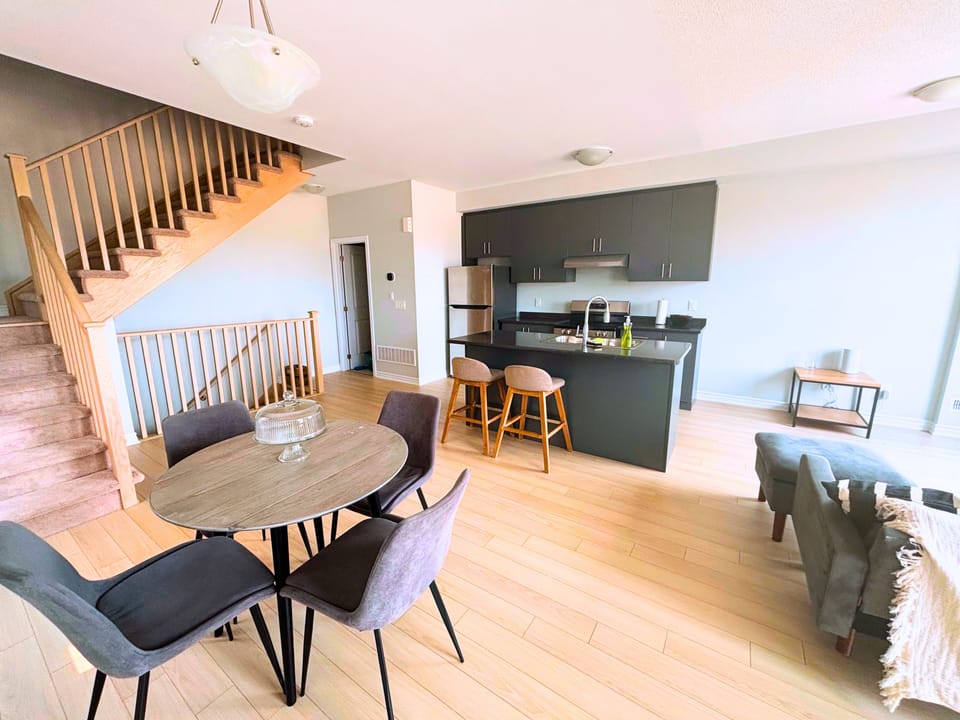 Large open concept kitchen, living and dining with access to balcony.