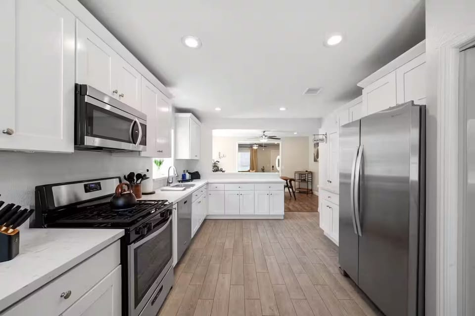 Stylish kitchen opens to dining area, perfect for cooking and gathering.