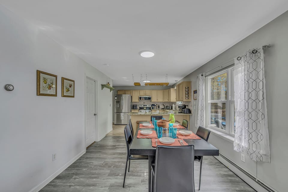 Dining table. Two additional tables in rooms over can fit for more seating.