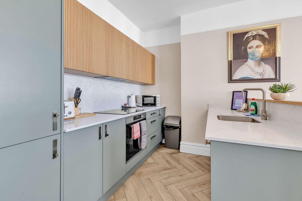 Stylish kitchen area featuring electric hob, oven, dishwasher and ample counter spac