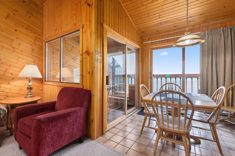 Dining nook with sliding doors that open to lake views.