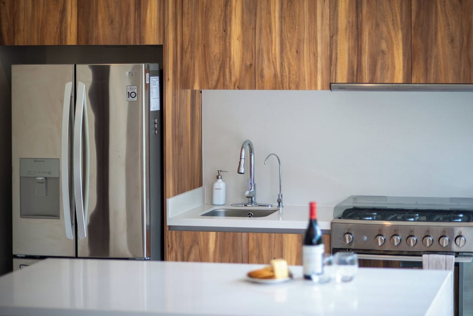 kitchen equipped with stainless steel appliances and microwave