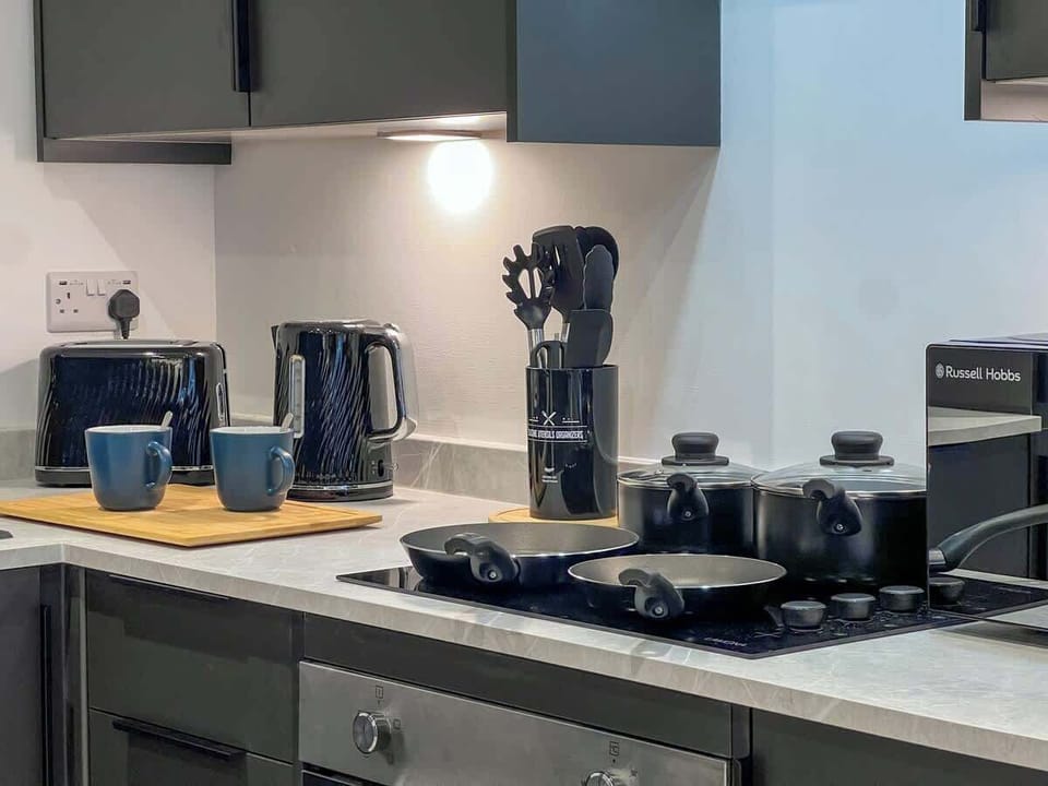 Fully Equipped Kitchen With Pots, Pans and Mugs