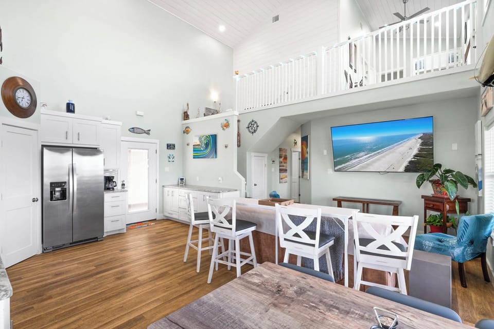 Bright, open-concept living and kitchen area with island seating.

