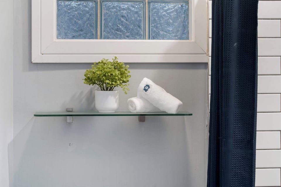 Minimal wall shelf w/ greenery adding a soft, calming touch
