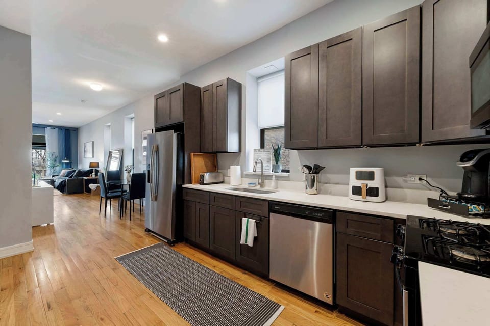 Sleek kitchen w/ modern appliances, dark cabinetry, and a clean layout for easy cooking
