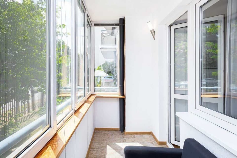 Additional views of the enclosed balcony from different angles, highlighting the relaxing seating arrangement.
