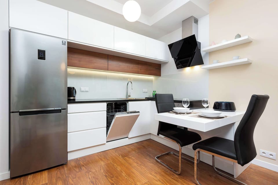 Kitchenette with dishwasher and dining table.